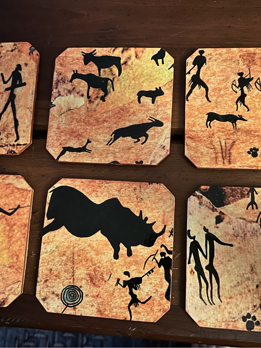 Rustic Cave Art Animal Coasters - Black on Tan and Orange